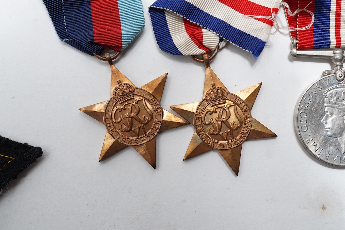 A First World War Mons Star trio awarded to Capt. A.D. Lowdell, with a clasp for 5th Aug-22nd Nov 1914, and oakleaf - mention in dispatches, together with the miniature set, plus a WWII Defence medal in its original card